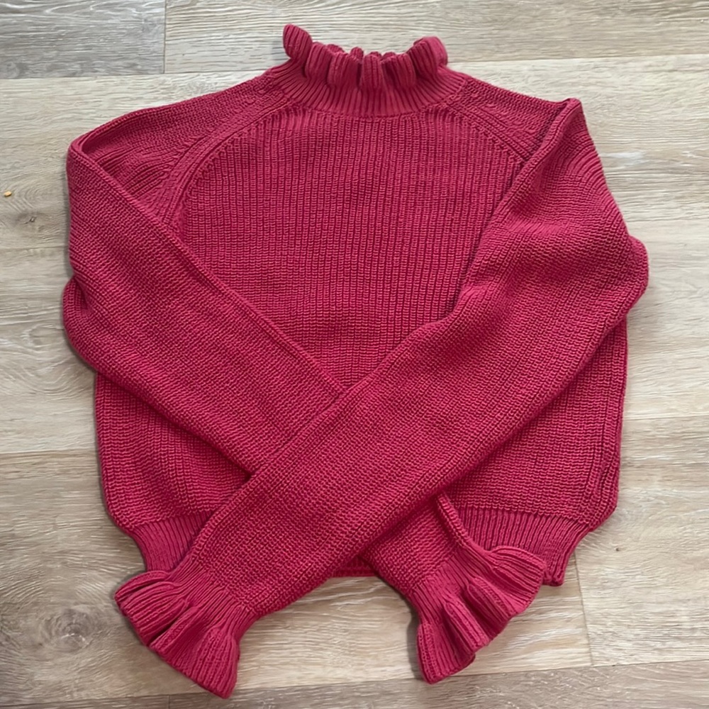 Pink sweater with ruffle neck and cuffs